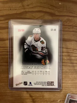 22-23 Skybox Metal Universe Lukas Reichel Premium Prospects Ruby 13/50 back