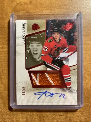 Alex Vlasic 2022-23 UD SPX Ruby Rookie Logo Patch Auto /49 Blackhawks front