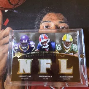 2007 Adrian Peterson, Marshawn Lynch, Brandon Jackson Rookie Rare Remnants Gold /25 front